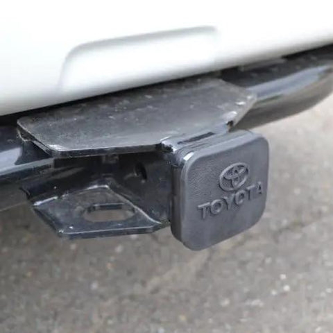 Toyota Stainless Steel Trailer Hitch Cover PT22835960HP installed on a car, showing heavy duty and weatherproof design.