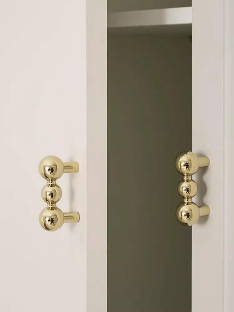Heavy Duty Solid Brass Cabinet Knob With A Slick Single Hole Design And Top Shelf Modern Hardware Upgrade For Kitchens Cupboards Wardrobes And Bedroom Furniture on white cabinetry.