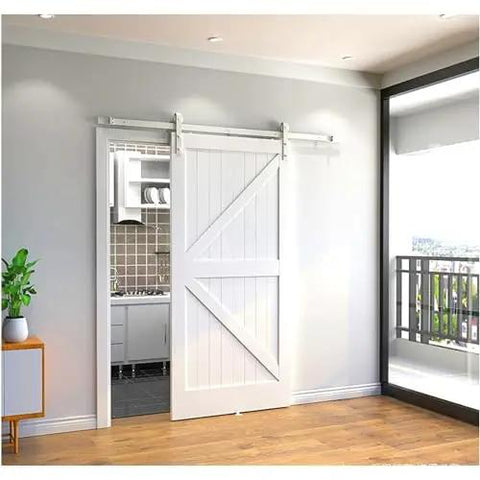 Heavy Duty Double Bypass Sliding Barn Door Hardware Kit With Low Profile Flat Track System in modern kitchen setting.