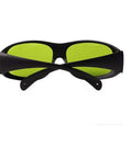 Top Shelf Laser Safety Glasses Lock Out Intense 755 808 And 1064 Nm NdYag Beams Via Thick Clear Lenses with black frame and green lenses.