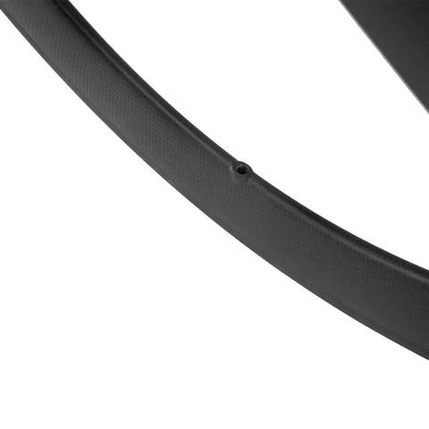 Close-up of Full Carbon Tri Spoke 700C Clincher Wheelset For Fixie Rigs Lightweight Aero Front Wheel for smooth ride on rough roads.