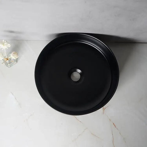 USZWBY Vessel Sinks Nordic Matte Black Round Art Sink above counter view, ceramic wash basin on marble surface.