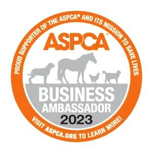 ASPCA Business Ambassador 2023 badge with orange circular border and horse silhouettes.