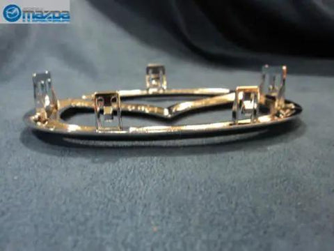 Mazda Front Logo Emblem C235 51 731A Replacement, rear view showing mounting clips, for 2006-2013 Mazda2, Mazda3, Mazda5, Mazda6