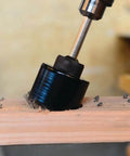 Spyder 1/2-in hex hole saw pilot bit with black housing drilling into wood