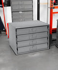 Durable Steel Compartment Box Rack With Four Adjustable Divider Boxes And Large Slide Shelf, installed in workshop