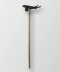 Wooden-handled garden hoe with black metal head against white background