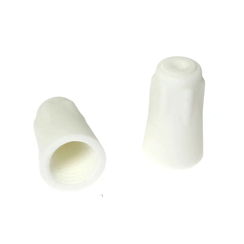 Close-up of two white large ceramic wire connectors for high-temperature splicing