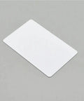 Top Shelf White Blank Pvc Cards For Crisp Inkjet Printing Waterproof Plastic Id Badges And Business Cards No Rfid Chip on gray background.