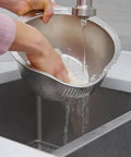 Person using Stainless Steel Rice Washer Strainer Bowl With Agitator Bumps For Quick No Fuss Rinsing in kitchen sink