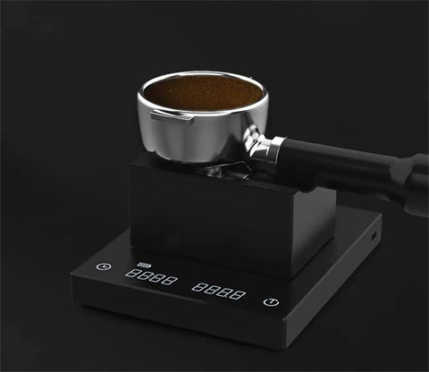 Solid Kickass Coffee Tamping Station With Integrated Espresso Scale Base with portafilter on black surface.