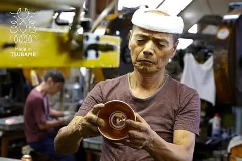 Craftsman inspecting Copper Coffee Dripper TSUBAME WDC-185 For Two To Four Folks Pour Over Cone, Made in Japan workshop