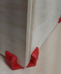 Close-up of 4 Pack Right Angle Corner Clamps For Cabinet Making And Box Assembly, securing a wooden board at a 90 degree angle.