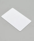 Top Shelf Blank Inkjet Printable Pvc Cards Waterproof Plastic Id And Business Card Stock on gray surface, showing flat white card.