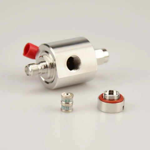 Close-up of Solid SMA Lightning Arrestor Surge Protector with SMA male to female connector, gas tube element visible, RF protection device.