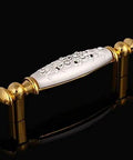 Modern 96Mm Cabinet Pull And Drawer Knob Featuring Crisp White Base With Dazzling 24K Gold Crystal Accent on a black background.