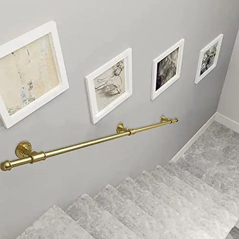Hella Sturdy Gold Wrought Iron Handrail For Elderly And Kids Safety Stair Railing mounted on a staircase wall with framed art.