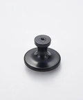 Close-up of a single matte black cabinet knob from Six Pack Matte Black Cabinet Knobs Zinc Alloy Round Cupboard Drawer Pulls For Dresser