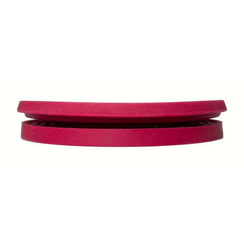 Side view of folded red collapsible pour over coffee dripper for camping, lightweight and durable silicone design.