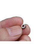 Close-up of 0.3 Module Planetary Gearbox With 5.95mm Outer Diameter, 2.55mm Inner Hole, held between fingers for scale.