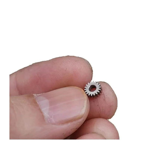 Mini Planetary Gearbox Reducer 0.3 Module 5.95mm Diameter 2.55mm Bore 18 Teeth held between fingers for close-up view