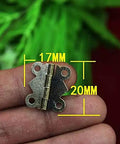 Close-up of a 20x17mm mini hinge held in hand, part of the 10 Pcs Mini Hinges For Dollhouse And Jewelry Box Projects Handy Wood Door And Drawer Hardware Set.