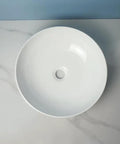 USZWBY Vessel Sinks Modern Simple Round Sink Home Bathroom Above Counter Basin Shopping Mall Toilet Ceramic Wash Bathroom Bowl Sink top view on marble surface.