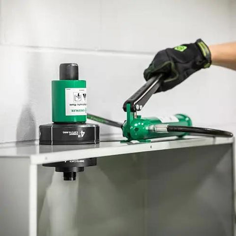 11 Ton Hydraulic Knockout Punch Kit With Hand Pump And Ram in use on metal panel