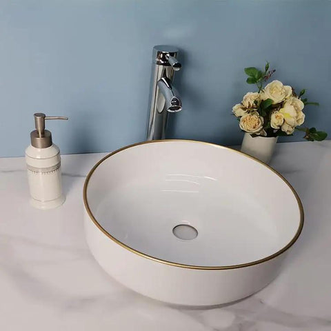 USZWBY Vessel Sinks Simple Hotel Bathroom Ceramic Sink Home Round Above Table Basin with gold rim and modern faucet.