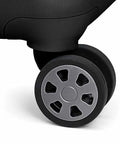 Traveler's Choice Pagosa luggage spinner wheel close-up on black hardshell carry-on