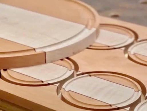 Close-up of wood cutouts made by Grade A Circle Jig For Woodworking Delivers 268 Circle Cuts From One And A Half Inches To Eighteen And Three Sixteenths Inches In One Sixteenth Increments Compatible With Standard And Pro Router Models Killer For Speaker Cutouts Rings And Inlays Works.
