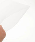 Close-up of a hand holding a white EPE foam pouch from 100 Pack Foam Pouch Bags For Shipping And Mailing Small Electronics And Photo Frames.