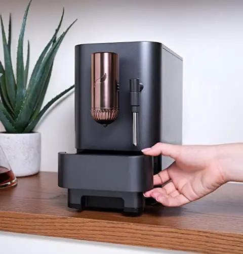 Top Shelf Wifi Automatic Espresso Machine With Built In Milk Frother And Adjustable Bean Grinder One Touch Brew In Under Ninety Seconds Matte Black on kitchen counter with plant in background.