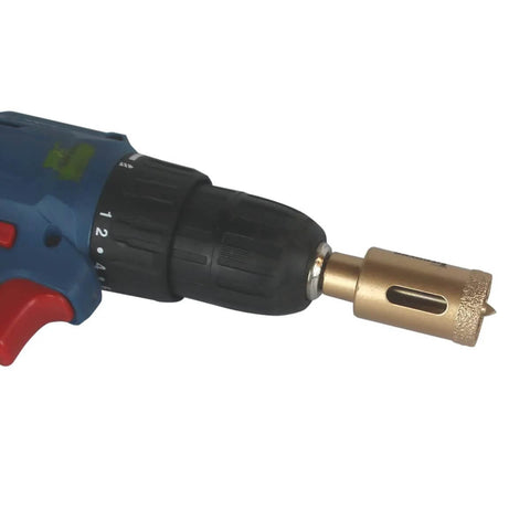 JIECHENG 1-inch brazed-diamond hole saw with center drill bit mounted on a drill chuck