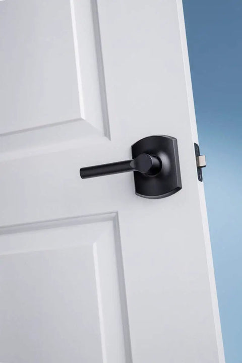 Broadway Lever With Greenwich Trim Keyed Entry Lock Matte Black Finish on open door, showcasing ease of installation.