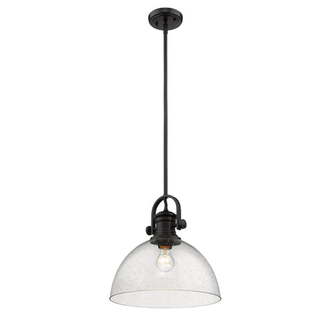 Hines Pendant Light In Matte Black With Seeded Glass Shade hanging against white background, showcasing modern farmhouse style.