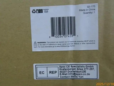Close-up of a shipping label with barcode and warning information on a cardboard box.