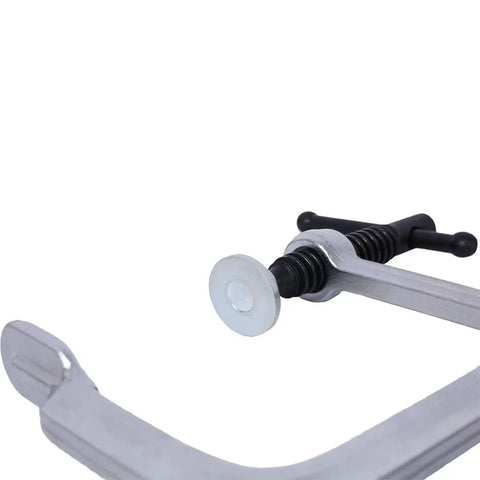 Close-up of heavy duty F clamp showcasing drop forged steel construction and quick release lever for woodworking tasks.