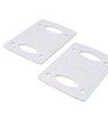 Close-up of two white risers and shock pads one eighth inch for scooters and bikes, showing cushioned support and grippy control.