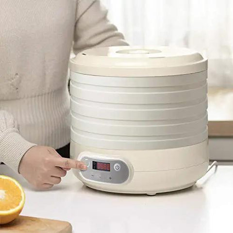 Kicking Up Your Snacking Game With This Electric Fruit Dehydrator featuring a beige shell and five sturdy trays, precise temp controls.