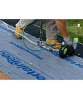 Worker installing Top Shelf Synthetic Roof Underlayment Roll Heavy Duty Water Blocked Roofing Felt Alternative with tough woven core.