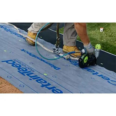 Worker installing Top Shelf Synthetic Roof Underlayment Roll Heavy Duty Water Blocked Roofing Felt Alternative with tough woven core.