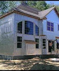 Heavy Duty Reflective Insulation Roll With Foam Core Covers 400 Square Feet applied on a house exterior during construction.