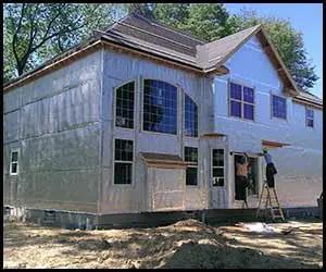 Heavy Duty Reflective Insulation Roll With Foam Core Covers 400 Square Feet applied on a house exterior during construction.