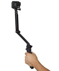 Hand holding 3 In 1 Do It All Action Camera Grip Arm And Tripod For All In One Stability, Detachable Handle For Handheld Shots.