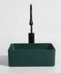 USZWBY Vessel Sinks Nordic Countertop Basin Matte Green Ceramic Square Washbasin with black faucet in a modern setting