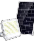 Badass Solar Led Flood Light With Advanced Motion Sensor IP66 Waterproof Outdoor Security Fixture Tough As Nails Die Cast Aluminum Build For Fences And Patios Super Bright Daylight White next to solar panel.