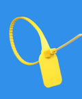 Close-up of a single yellow self-locking cable tie with white label board, part of the 50 Self Locking Cable Ties With White Label Boards For Straight Up Cord Management No Sweat Wire Organizer Bundle Wrap Top Shelf Heavy Duty Nylon Fastener Alternative.
