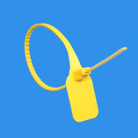 Close-up of a single yellow self-locking cable tie with white label board, part of the 50 Self Locking Cable Ties With White Label Boards For Straight Up Cord Management No Sweat Wire Organizer Bundle Wrap Top Shelf Heavy Duty Nylon Fastener Alternative.