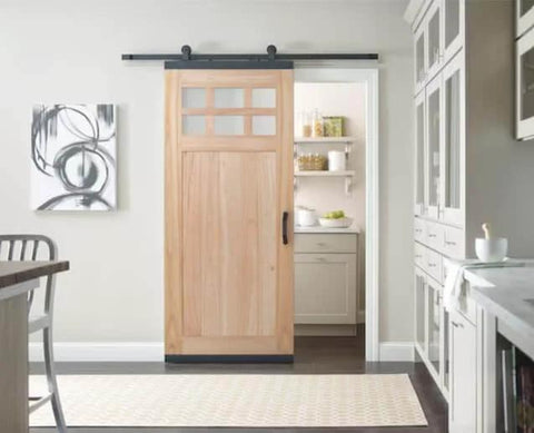 Soft Close Single Barn Door Hardware Kit in matte black for 36 inch doors, top mount track system installed in a kitchen.